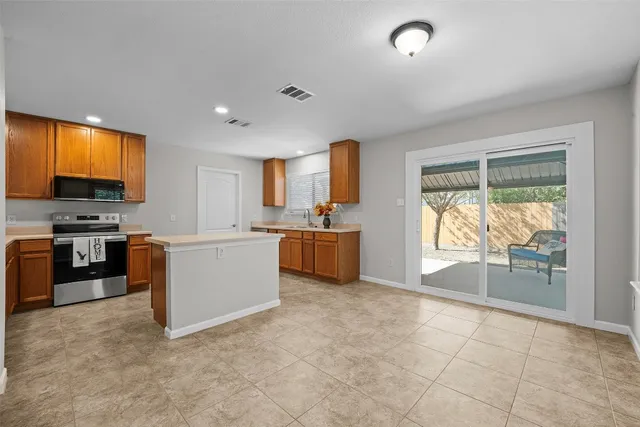 a kitchen with stainless steel appliances a stove sink and cabinets