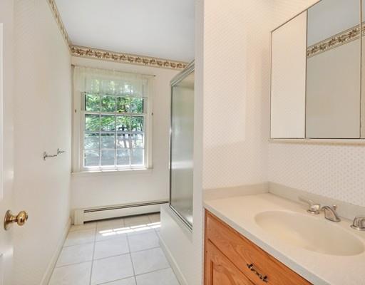 256 Hunters Ridge Road Concord, MA 01742 - Photo 11 of 16 a bathroom with a sink a mirror and a shower