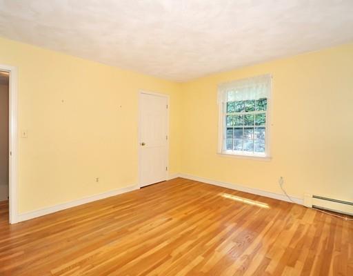 256 Hunters Ridge Road Concord, MA 01742 - Photo 12 of 16 an empty room with wooden floor and windows