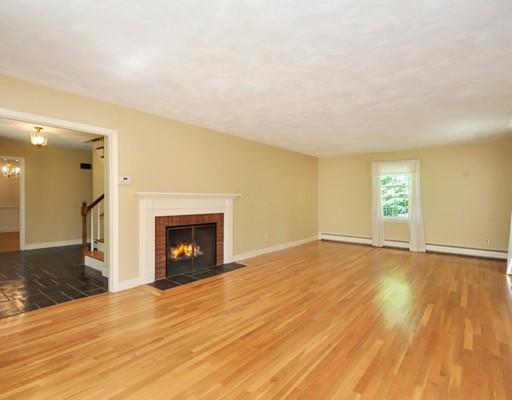 256 Hunters Ridge Road Concord, MA 01742 - Photo 3 of 16 an empty room with wooden floor and fireplace