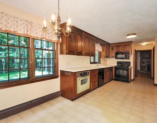 256 Hunters Ridge Road Concord, MA 01742 - Photo 5 of 16 a kitchen with stainless steel appliances granite countertop a stove a sink dishwasher and a microwave oven with cabinets
