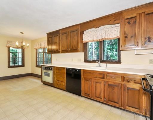 256 Hunters Ridge Road Concord, MA 01742 - Photo 6 of 16 a kitchen with stainless steel appliances granite countertop a stove a sink and a microwave