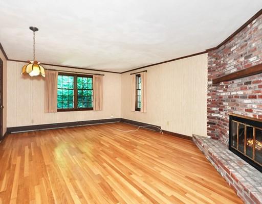 256 Hunters Ridge Road Concord, MA 01742 - Photo 7 of 16 a view of an empty room with a fireplace and a window