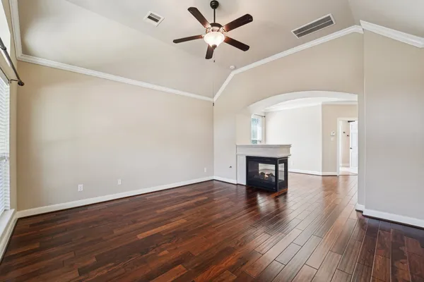 a kitchen with stainless steel appliances granite countertop a refrigerator and a stove top oven with white cabinets