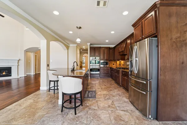 a bathroom with a granite countertop sink a mirror and shower