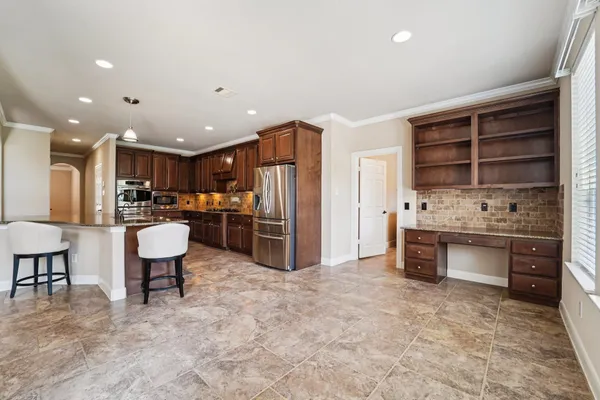 a view of a livingroom with wooden floor and a ceiling fan