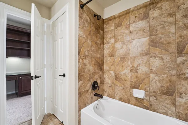 a view of a hallway to a livingroom with wooden floor and furniture