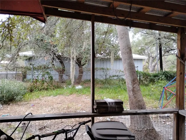 a view of a porch with furniture and floor to ceiling window