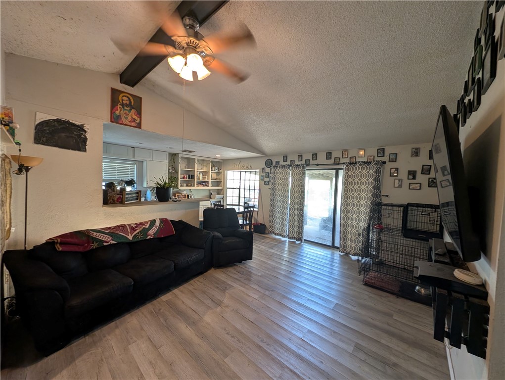 1980 Jocelyn Road Aransas Pass, TX 78336 - Photo 5 of 14 a living room with furniture a flat screen tv and a fireplace