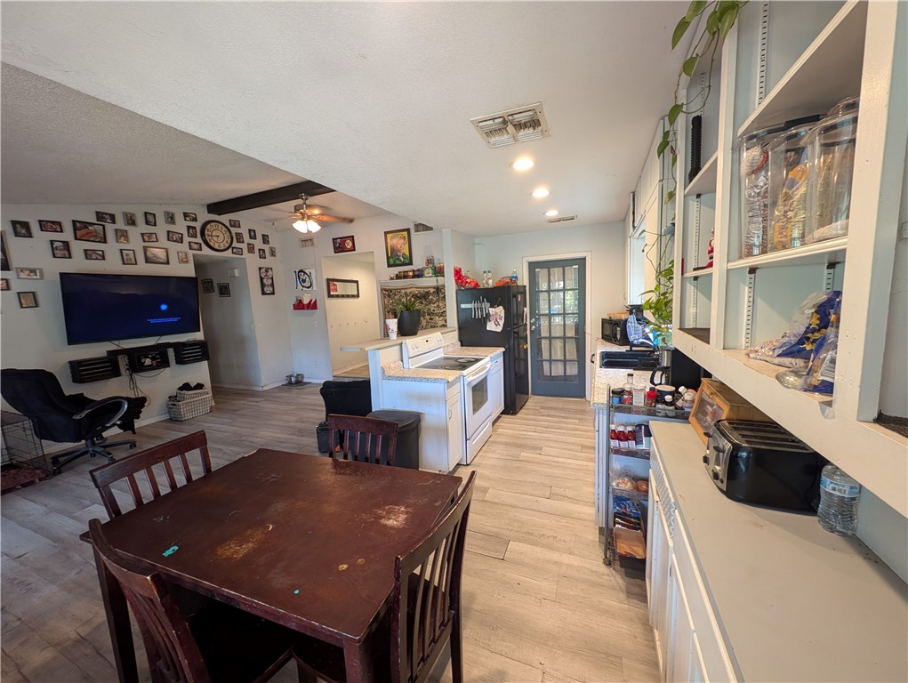 1980 Jocelyn Road Aransas Pass, TX 78336 - Photo 9 of 14 a living room with stainless steel appliances furniture a rug and a kitchen view