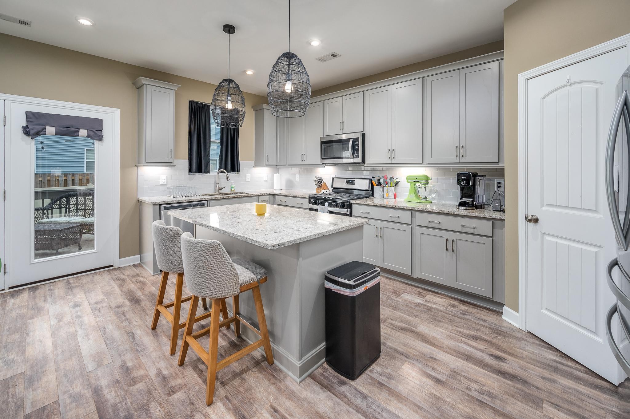 323 Disley Way Murfreesboro, TN 37128 - Photo 13 of 43 a kitchen with a sink a stove cabinets and wooden floor