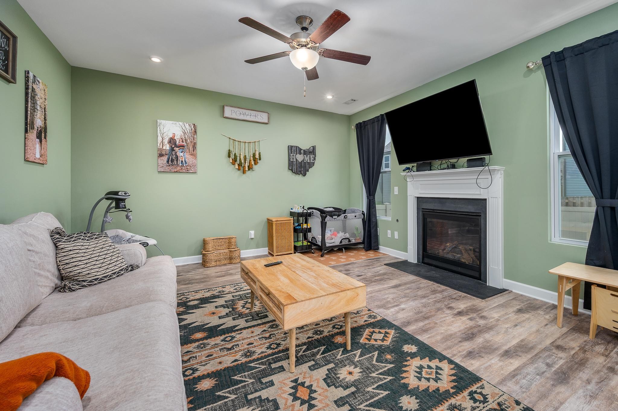 323 Disley Way Murfreesboro, TN 37128 - Photo 18 of 43 a living room with furniture a flat screen tv and a fireplace