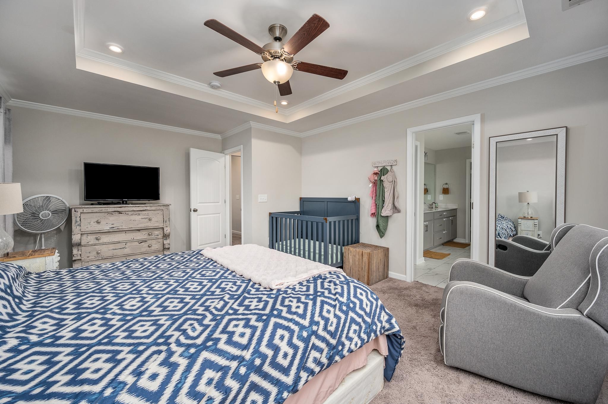 323 Disley Way Murfreesboro, TN 37128 - Photo 23 of 43 a spacious bedroom with a bed and a flat screen tv