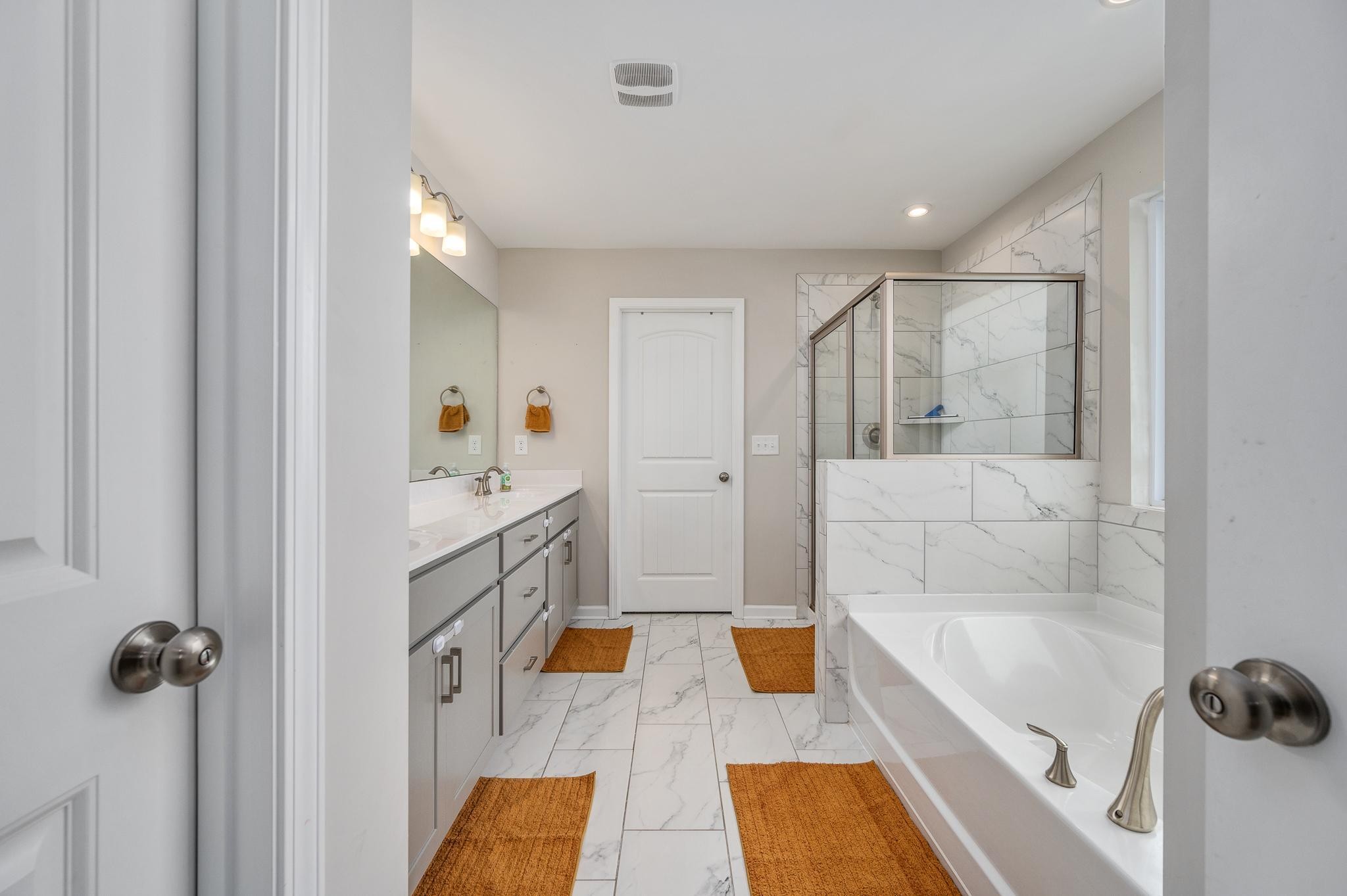 323 Disley Way Murfreesboro, TN 37128 - Photo 25 of 43 a bathroom with a tub sink and mirror