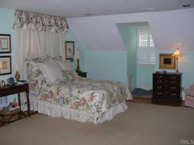 2818 Exeter Circle Raleigh, NC 27608 - Photo 7 of 10 a bedroom with a bed and a tv