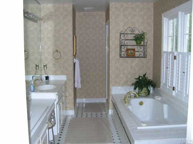 2818 Exeter Circle Raleigh, NC 27608 - Photo 8 of 10 a bathroom with a tub sink and mirror