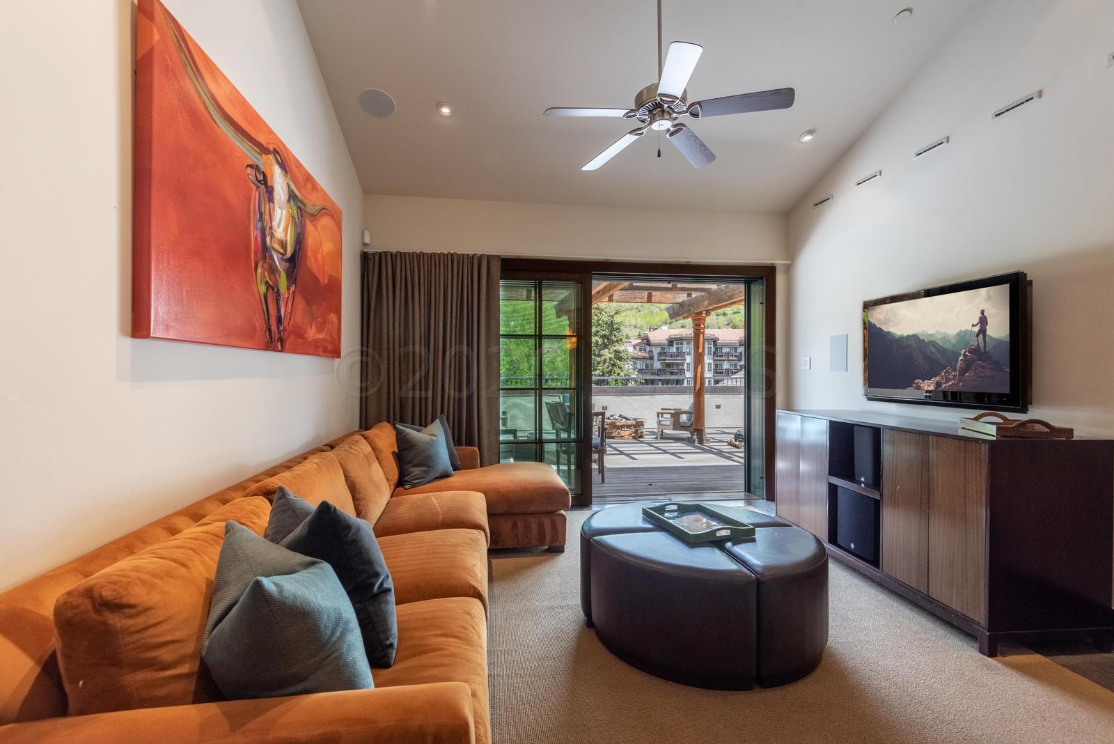 201 Gore Creek Drive, Unit R1 Vail, CO 81657 - Photo 13 of 42 a living room with furniture and a flat screen tv