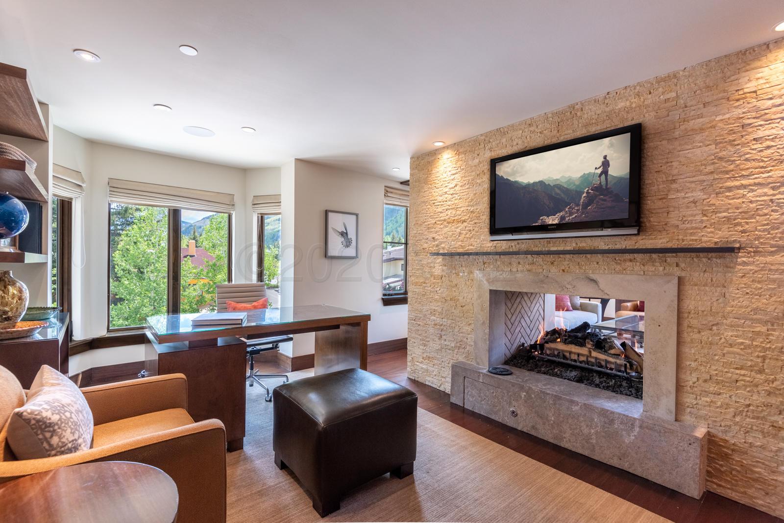 201 Gore Creek Drive, Unit R1 Vail, CO 81657 - Photo 14 of 42 a living room with furniture a flat screen tv and a fireplace