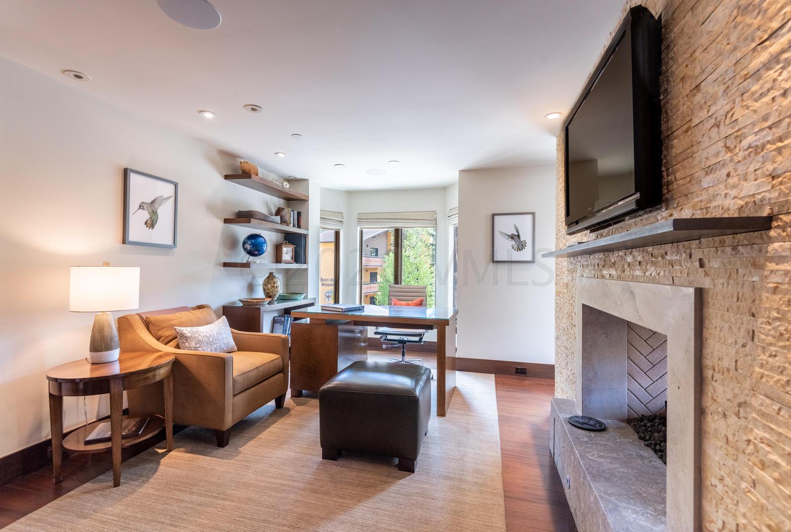 201 Gore Creek Drive, Unit R1 Vail, CO 81657 - Photo 15 of 42 a living room with furniture a flat screen tv and a fireplace