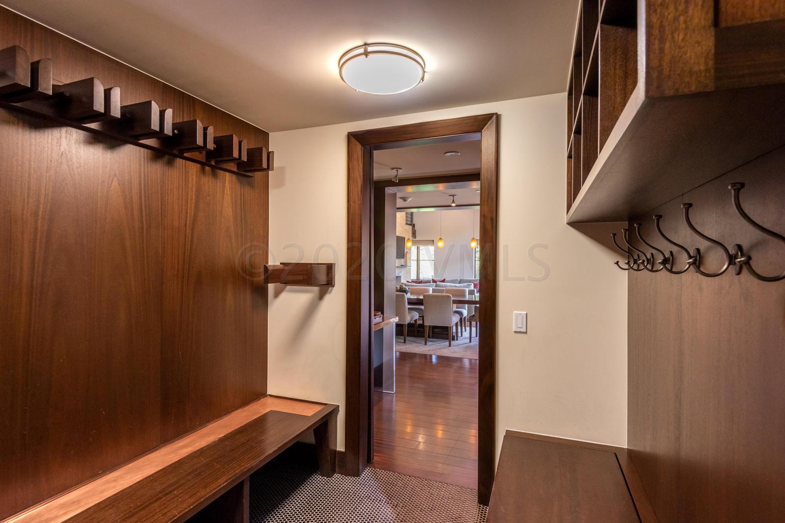201 Gore Creek Drive, Unit R1 Vail, CO 81657 - Photo 16 of 42 a hallway with a door and wooden floor