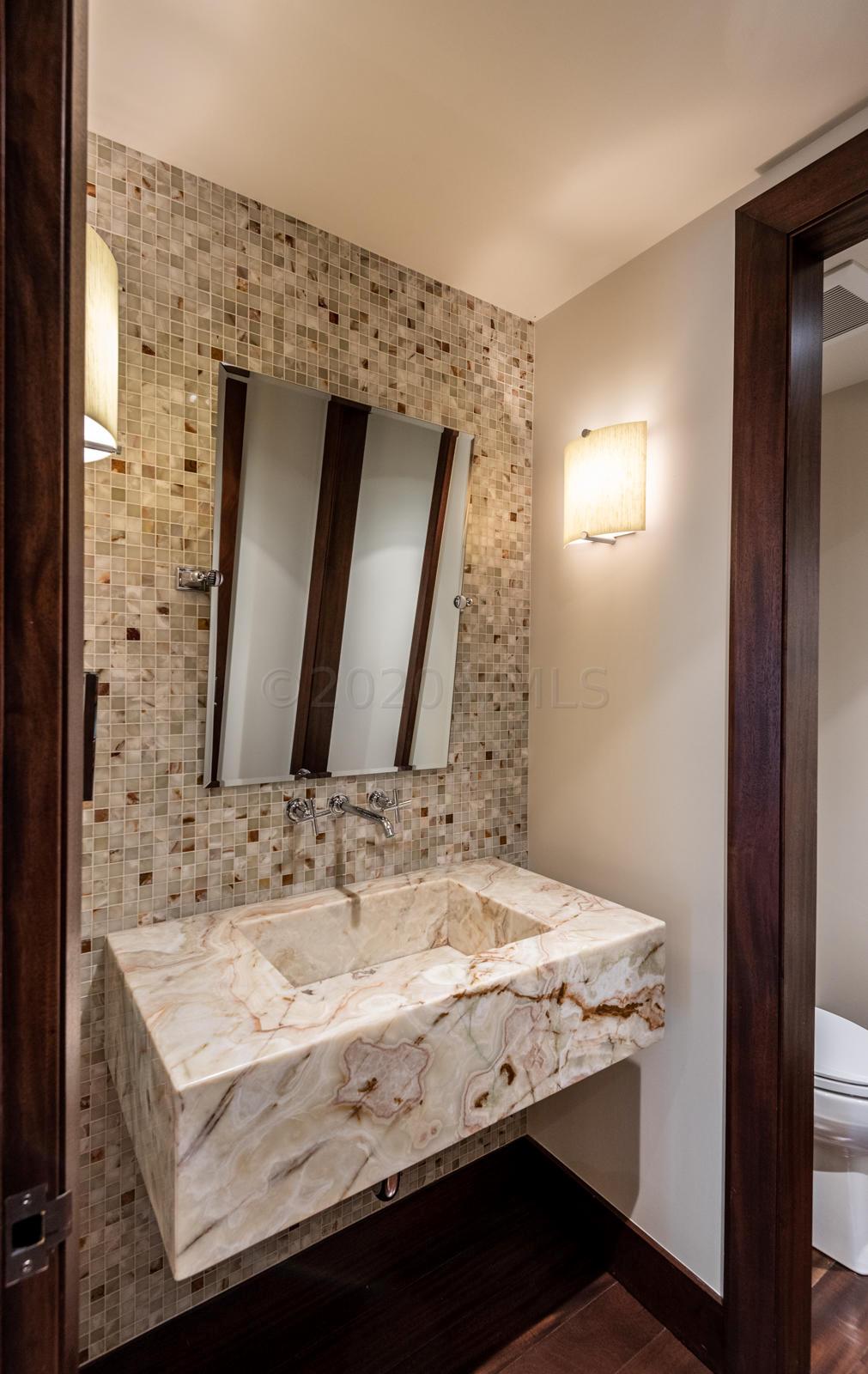 201 Gore Creek Drive, Unit R1 Vail, CO 81657 - Photo 17 of 42 a bathroom with a granite countertop sink and a mirror