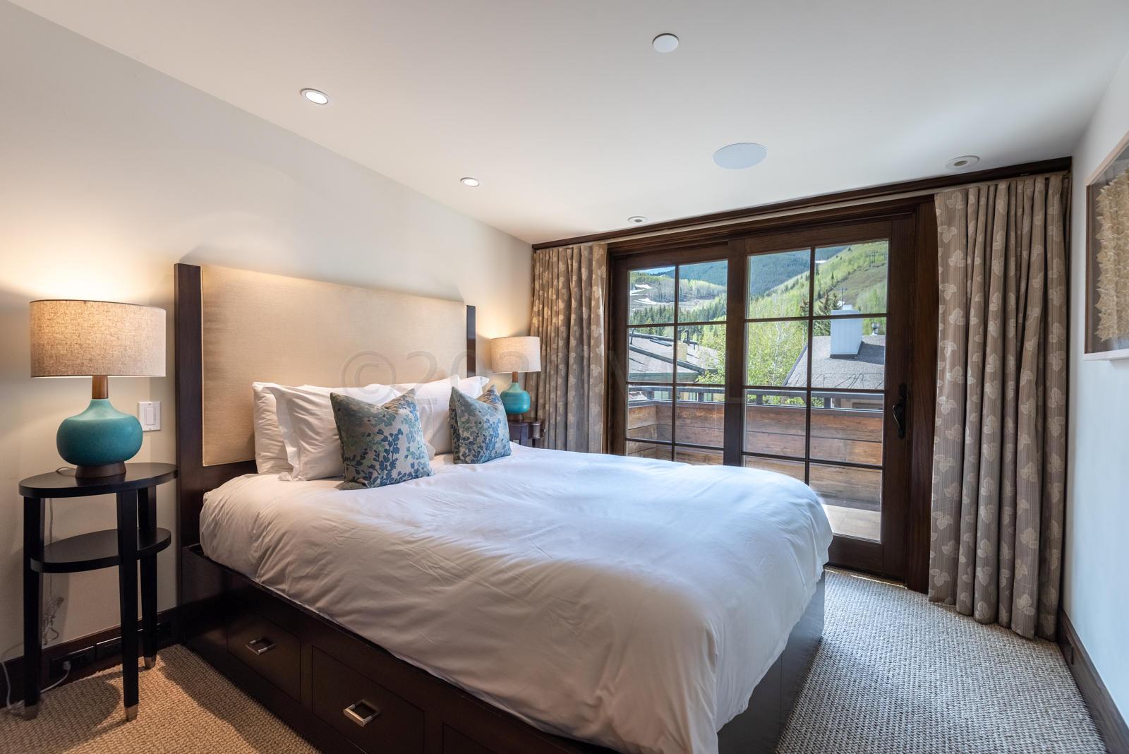 201 Gore Creek Drive, Unit R1 Vail, CO 81657 - Photo 19 of 42 a bedroom with a large bed and a large window