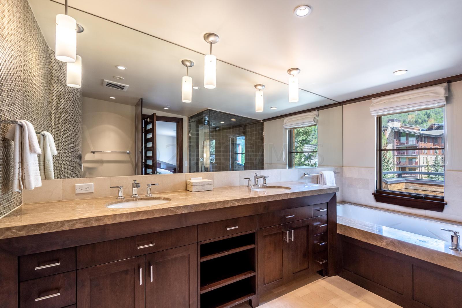 201 Gore Creek Drive, Unit R1 Vail, CO 81657 - Photo 20 of 42 a bathroom with a granite countertop sink and a large mirror