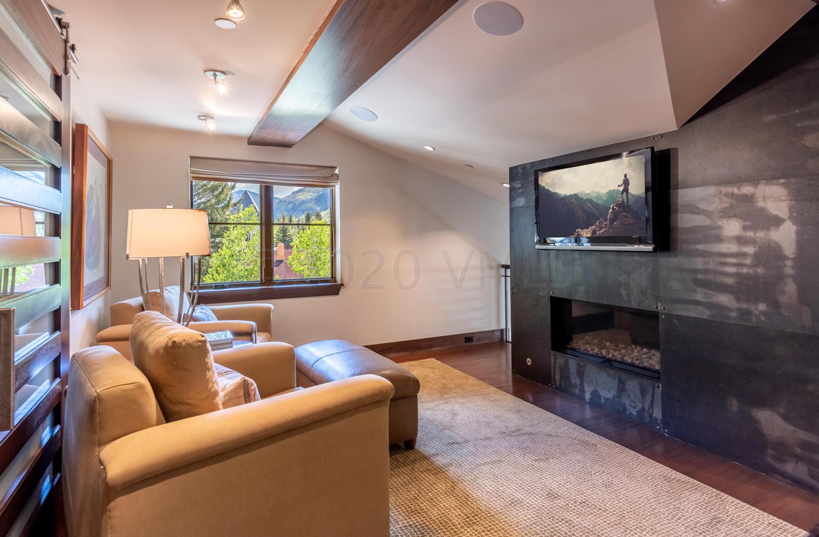 201 Gore Creek Drive, Unit R1 Vail, CO 81657 - Photo 23 of 42 a living room with furniture and a fireplace