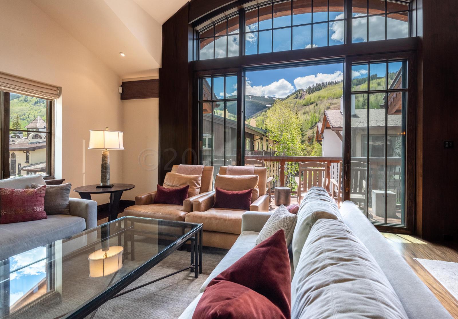 201 Gore Creek Drive, Unit R1 Vail, CO 81657 - Photo 3 of 42 a living room with furniture and a large window