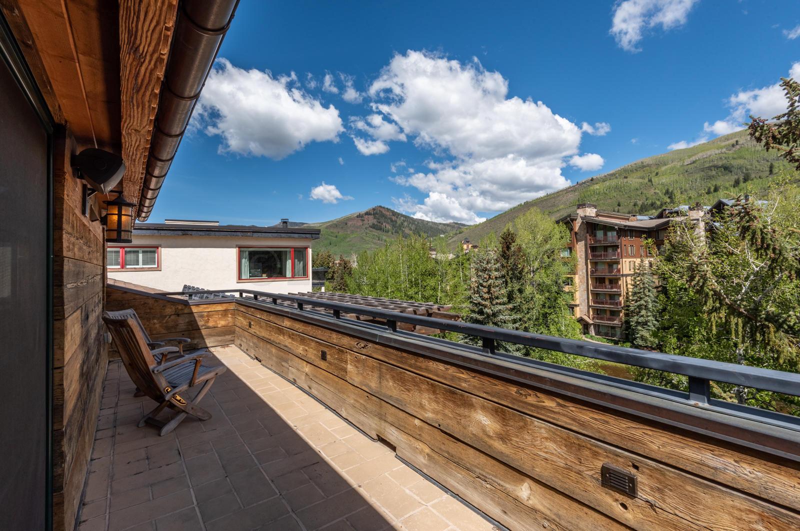 201 Gore Creek Drive, Unit R1 Vail, CO 81657 - Photo 32 of 42 a view of a balcony with chairs and wooden floor