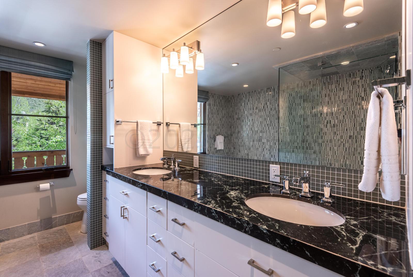 201 Gore Creek Drive, Unit R1 Vail, CO 81657 - Photo 36 of 42 a bathroom with a double vanity sink and a mirror