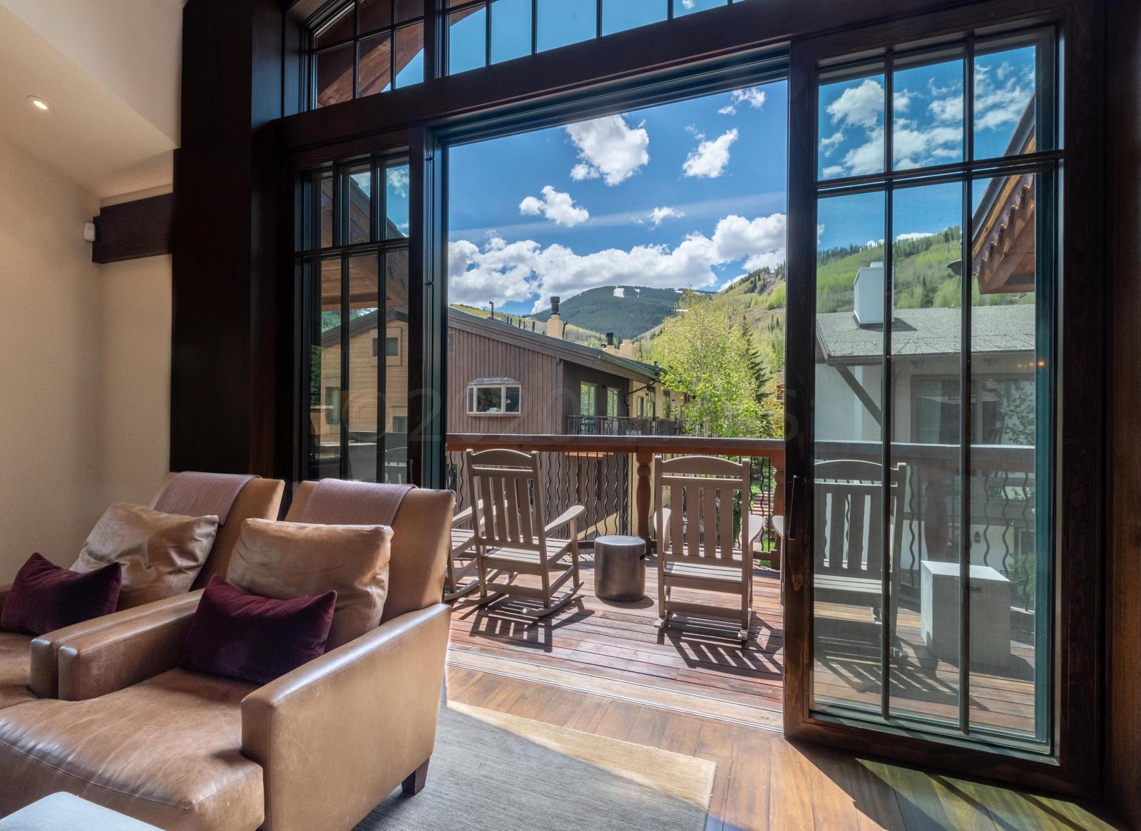 201 Gore Creek Drive, Unit R1 Vail, CO 81657 - Photo 5 of 42 a living room with furniture and a floor to ceiling window