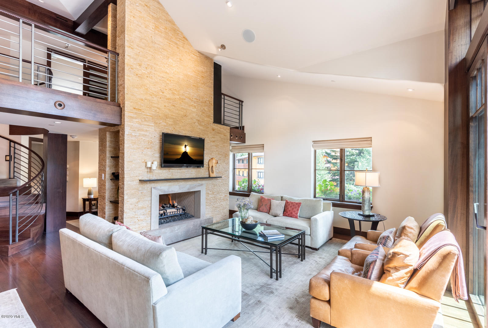 201 Gore Creek Drive, Unit R1 Vail, CO 81657 - Photo 6 of 42 a living room with furniture a flat screen tv and a fireplace