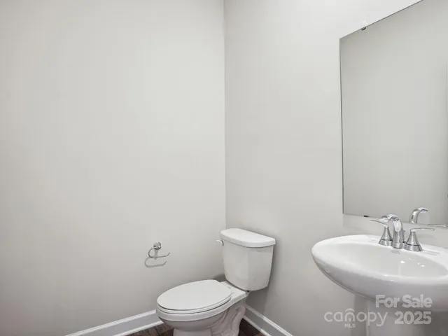 a white toilet sitting next to a white sink