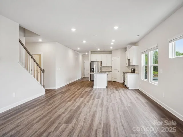 a view of a living room a wooden floor and a window