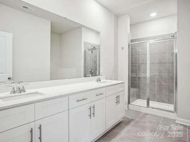 a bathroom with a granite countertop sink mirror and double