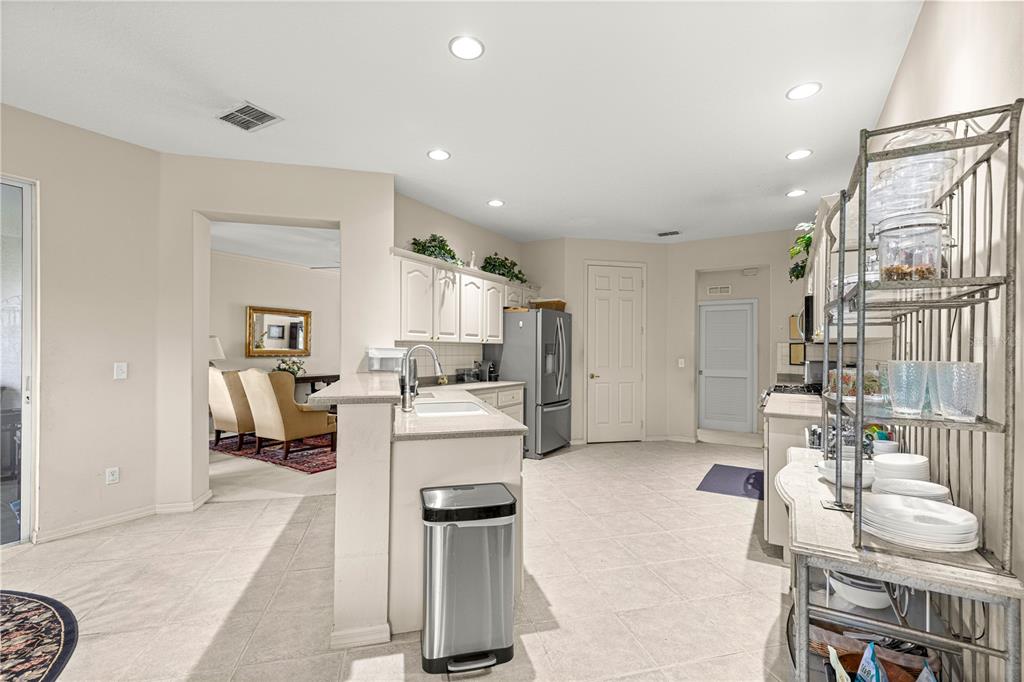 9110 Southwest 96th Court Road Ocala, FL 34481 - Photo 13 of 45 a living room with furniture and a refrigerator