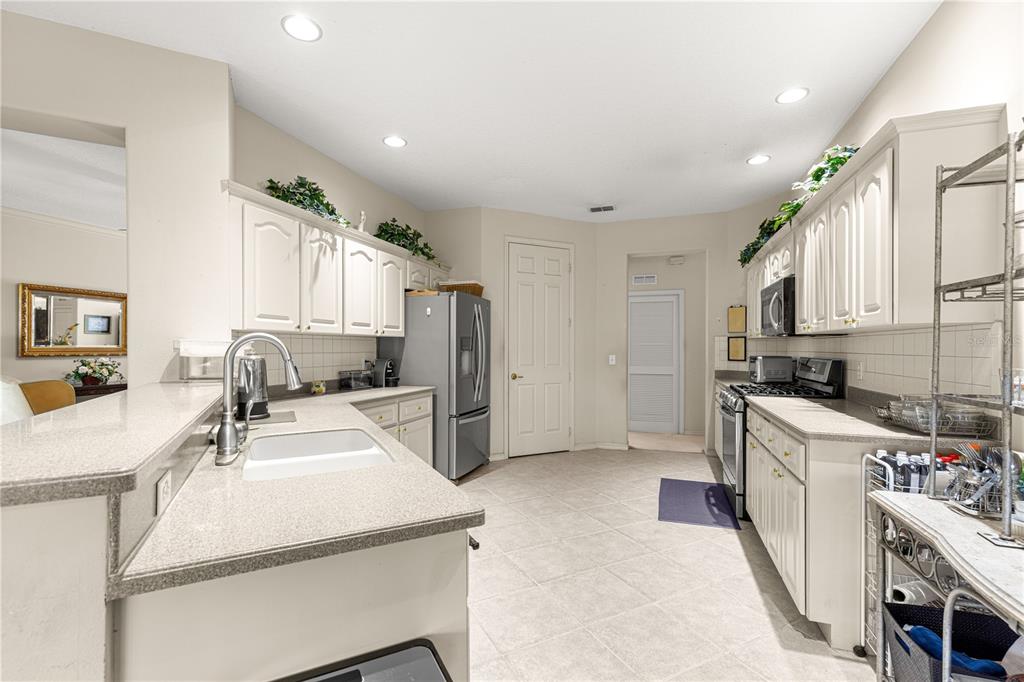9110 Southwest 96th Court Road Ocala, FL 34481 - Photo 14 of 45 a kitchen with a sink stove and refrigerator