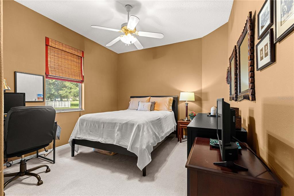 9110 Southwest 96th Court Road Ocala, FL 34481 - Photo 20 of 45 a bedroom with a bed tv and a window