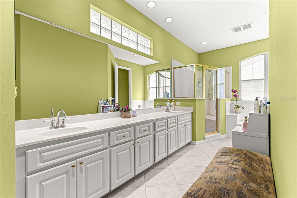 9110 Southwest 96th Court Road Ocala, FL 34481 - Photo 23 of 45 a spacious bathroom with a double vanity sink and a mirror