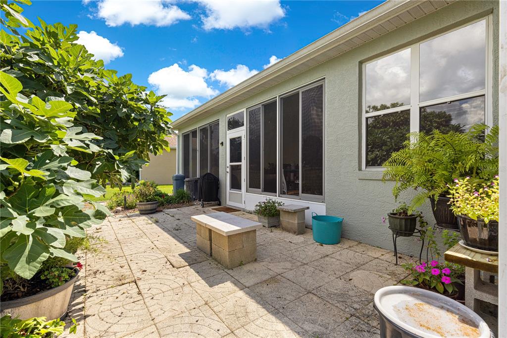 9110 Southwest 96th Court Road Ocala, FL 34481 - Photo 28 of 45 a view of a chair and tables in the patio with a backyard