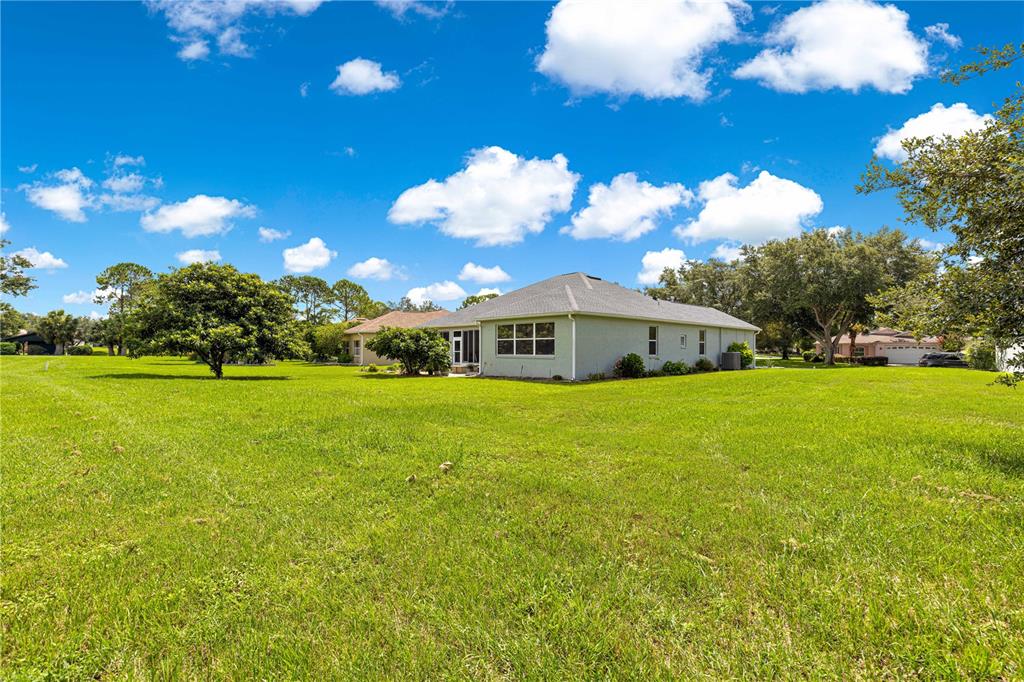 9110 Southwest 96th Court Road Ocala, FL 34481 - Photo 31 of 45 a front view of a house with yard and green space