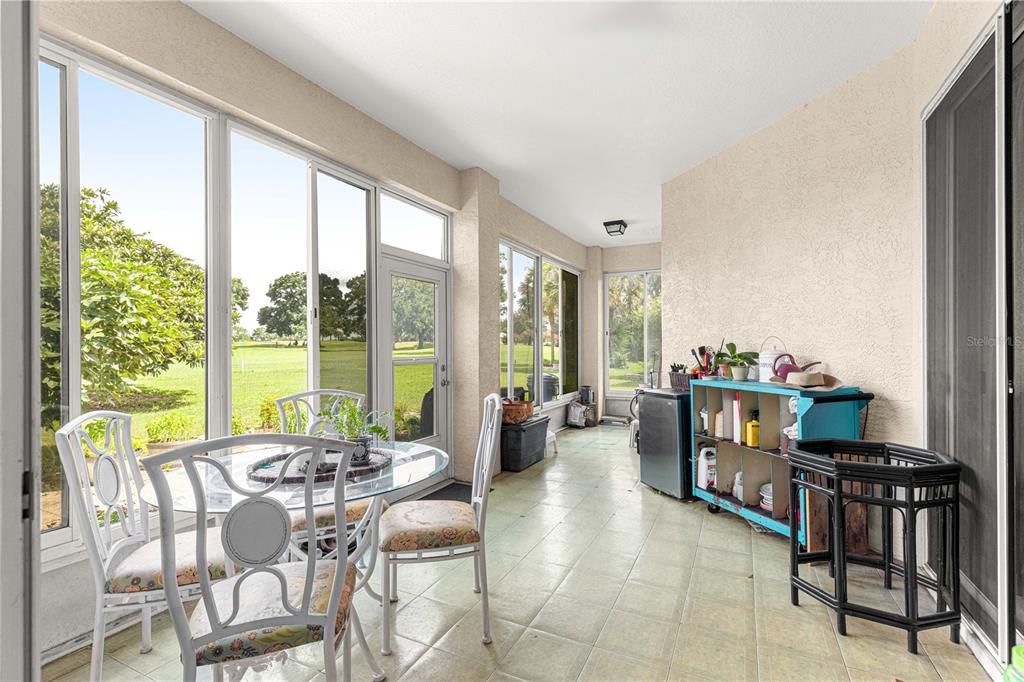 9110 Southwest 96th Court Road Ocala, FL 34481 - Photo 43 of 45 a living room with furniture and floor to ceiling windows