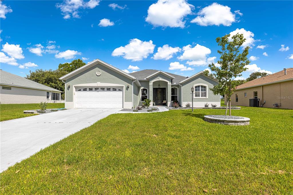 9110 Southwest 96th Court Road Ocala, FL 34481 - Photo 45 of 45 a view of a house with swimming pool and a yard