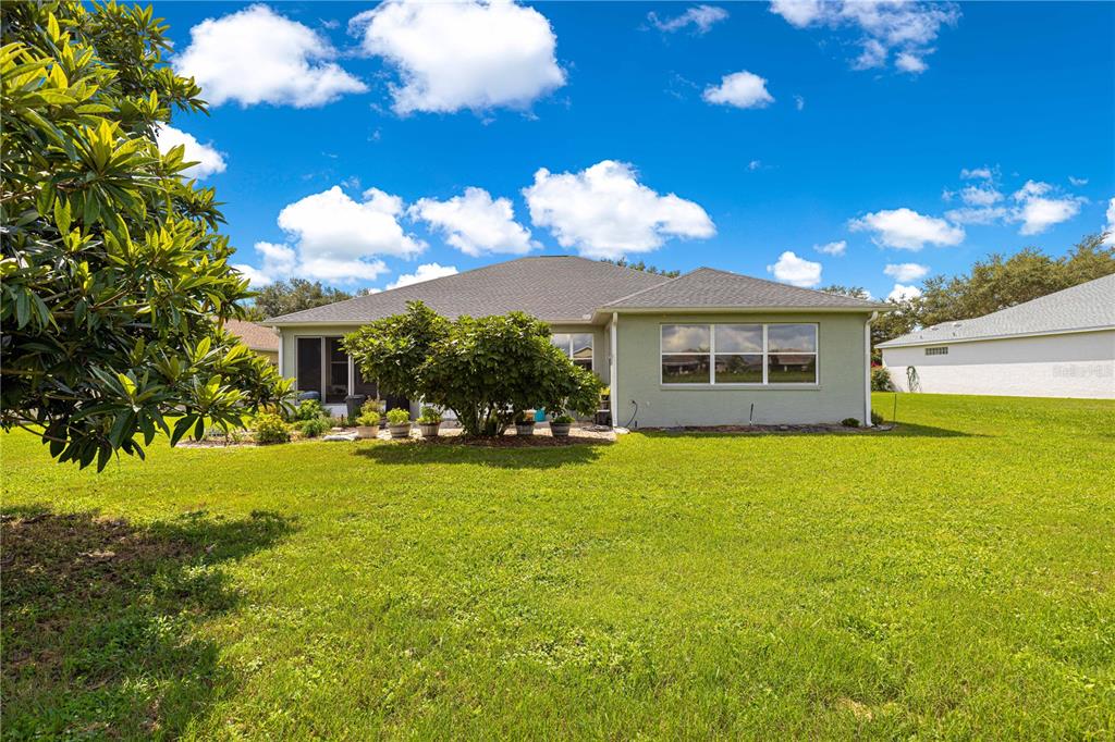 9110 Southwest 96th Court Road Ocala, FL 34481 - Photo 5 of 45 a view of a house with a backyard