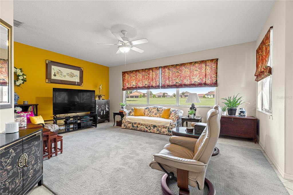9110 Southwest 96th Court Road Ocala, FL 34481 - Photo 9 of 45 a living room with furniture and a flat screen tv