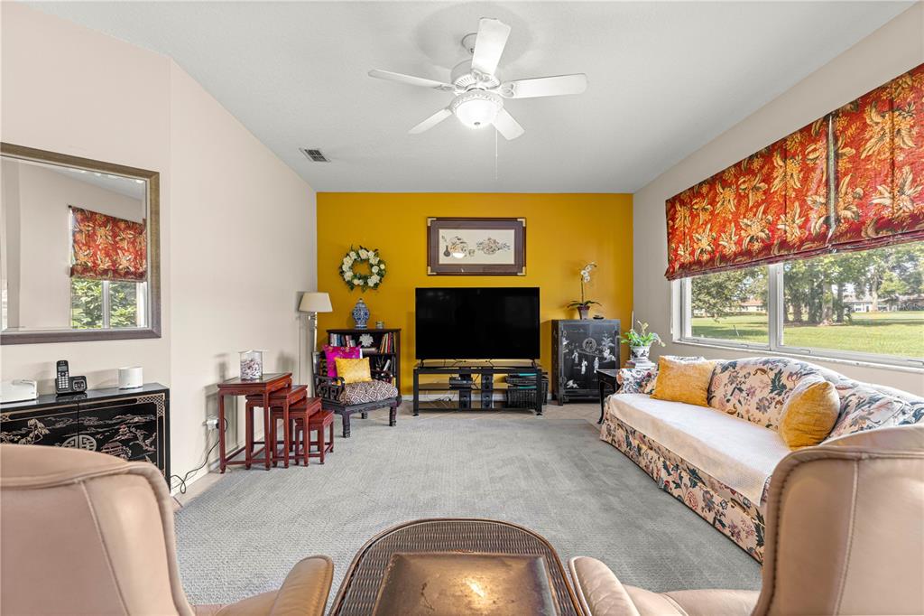 9110 Southwest 96th Court Road Ocala, FL 34481 - Photo 10 of 45 a living room with furniture and a flat screen tv