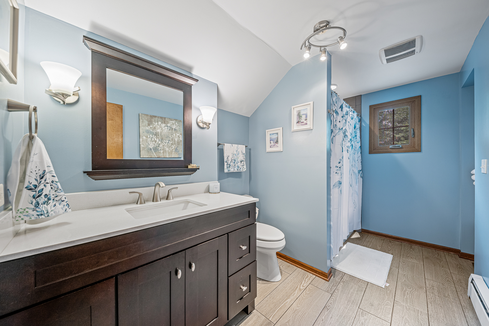 20735 Wolf Road Mokena, IL 60448 - Photo 13 of 22 a bathroom with a sink a toilet a mirror and shower