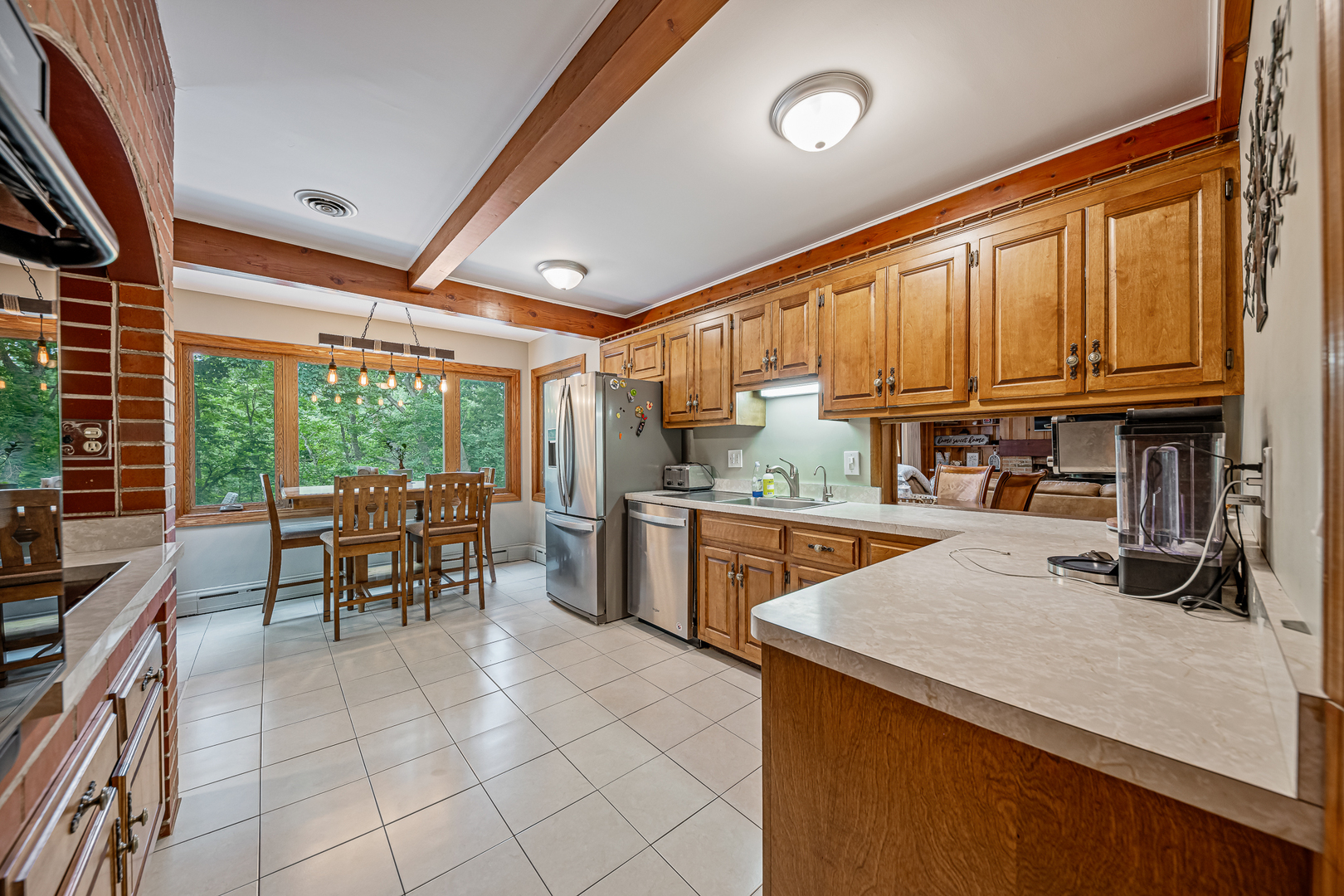 20735 Wolf Road Mokena, IL 60448 - Photo 5 of 22 a kitchen with granite countertop a stove a sink a dining table and chairs with wooden floor