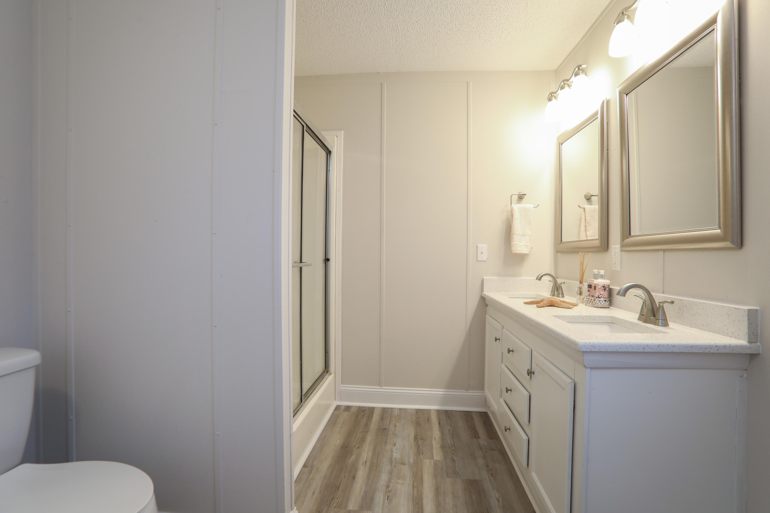 2080 West Kelley Road Baker, FL 32531 - Photo 12 of 20 a bathroom with a sink a toilet a mirror and vanity